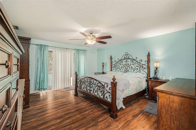 bedroom with ceiling fan, dark hardwood / wood-style flooring, and a textured ceiling