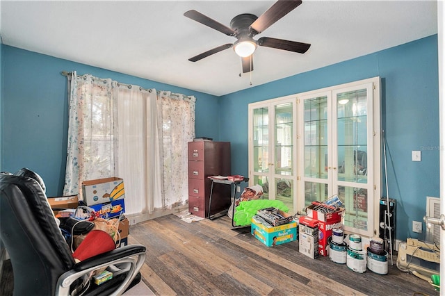 rec room with hardwood / wood-style floors and ceiling fan