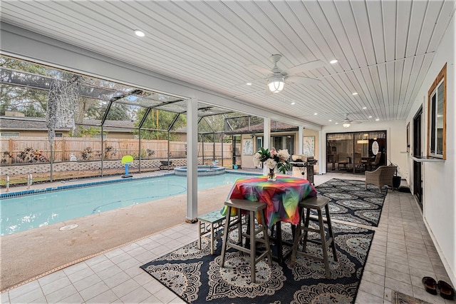 view of pool with an in ground hot tub, a patio area, ceiling fan, and a lanai