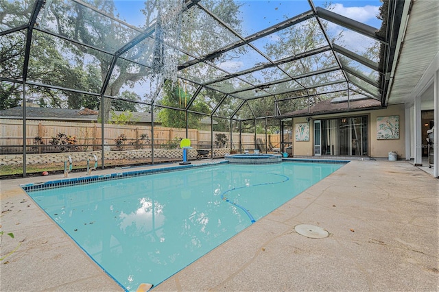 view of swimming pool with an in ground hot tub, a patio, and glass enclosure