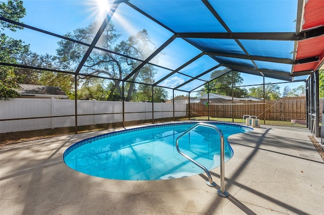 view of swimming pool featuring a lanai and a patio area