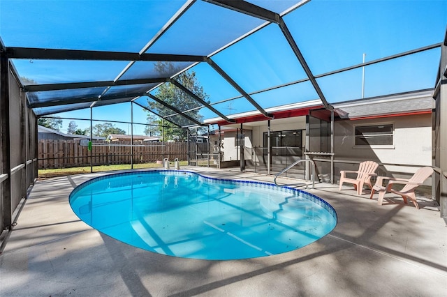 view of swimming pool with a patio area and glass enclosure