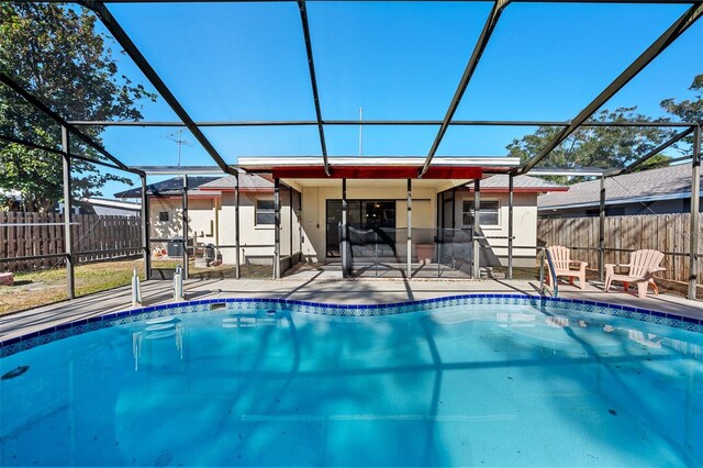 view of swimming pool with a patio area and glass enclosure