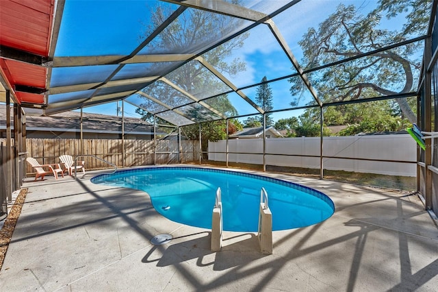 view of swimming pool featuring a lanai and a patio