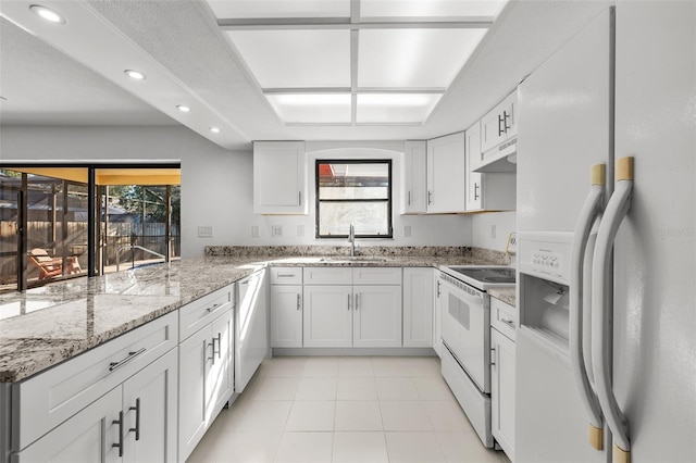 kitchen with white cabinetry, plenty of natural light, and white appliances