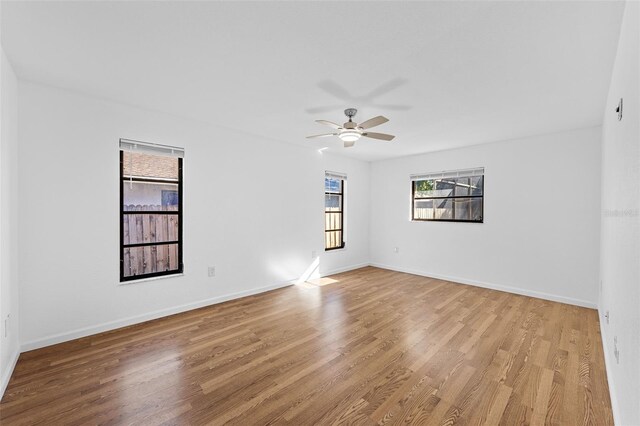 unfurnished room with ceiling fan, a healthy amount of sunlight, and light hardwood / wood-style floors