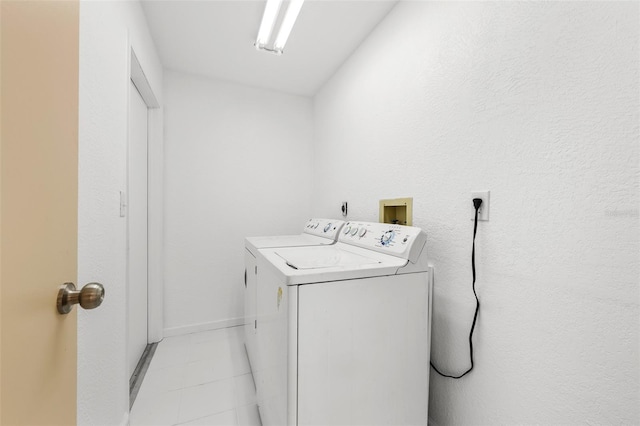 laundry room with light tile patterned floors and separate washer and dryer