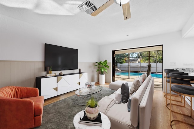 living room with hardwood / wood-style flooring and ceiling fan