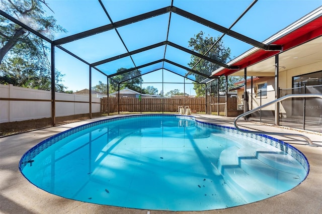 view of pool featuring glass enclosure and a patio area