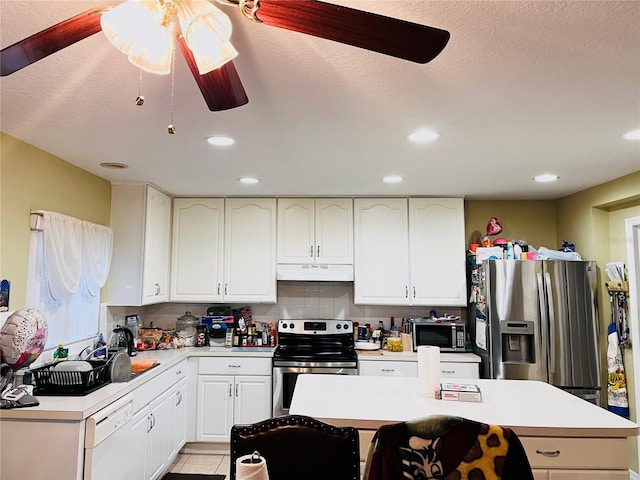 kitchen with ceiling fan, light tile patterned floors, decorative backsplash, and appliances with stainless steel finishes