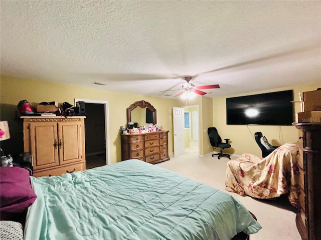 carpeted bedroom featuring a textured ceiling and ceiling fan