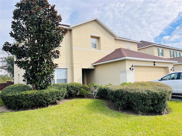 view of front of property with a garage and a front yard