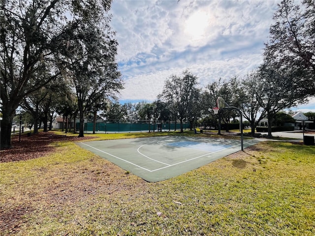 view of basketball court featuring a yard