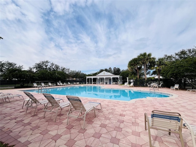 view of swimming pool with a patio