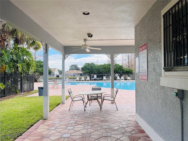 view of patio / terrace featuring ceiling fan and a community pool