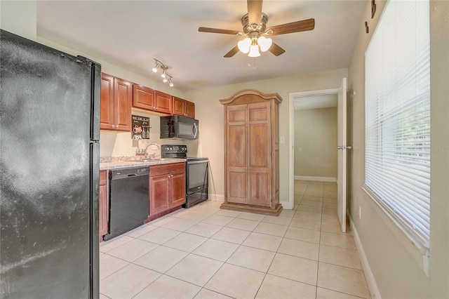 kitchen featuring black appliances, ceiling fan, light tile patterned flooring, and sink