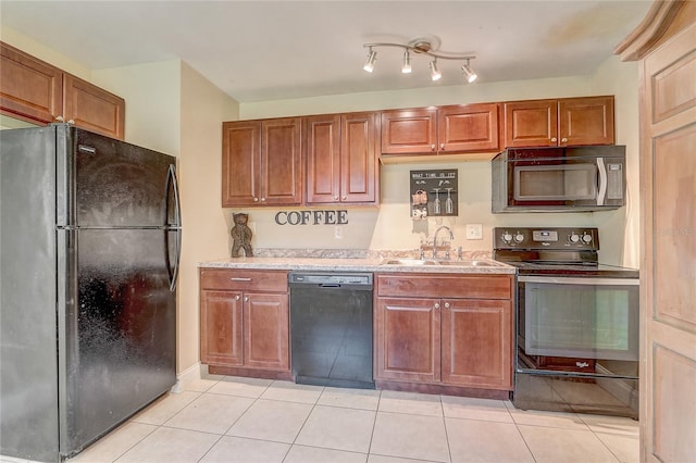 kitchen featuring sink, light tile patterned floors, and black appliances