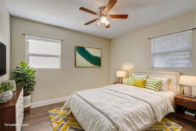 bedroom with ceiling fan and dark hardwood / wood-style floors