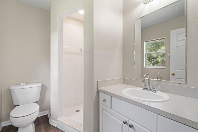 bathroom featuring vanity, toilet, wood-type flooring, and walk in shower