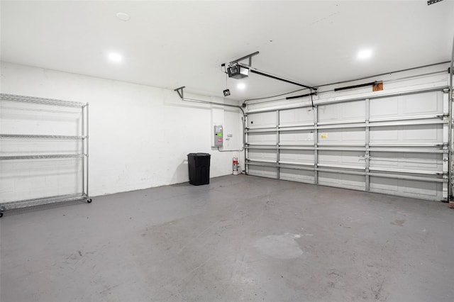 garage with electric panel and a garage door opener