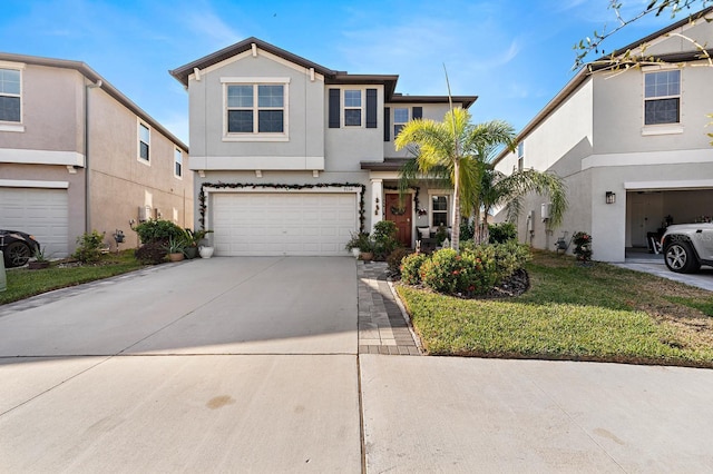 view of front property featuring a garage and a front lawn