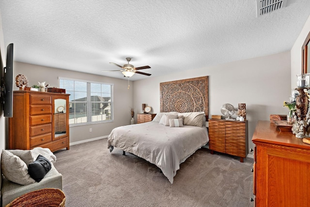 bedroom with dark colored carpet, a textured ceiling, and ceiling fan