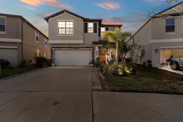 view of front of property with a yard and a garage