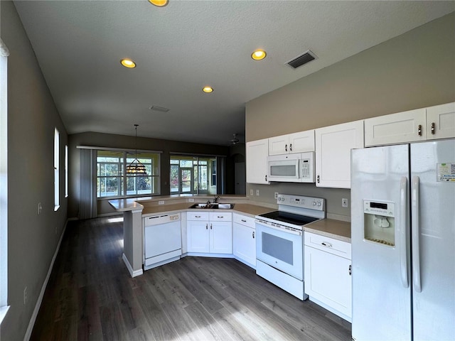 kitchen featuring sink, white appliances, hanging light fixtures, white cabinets, and kitchen peninsula