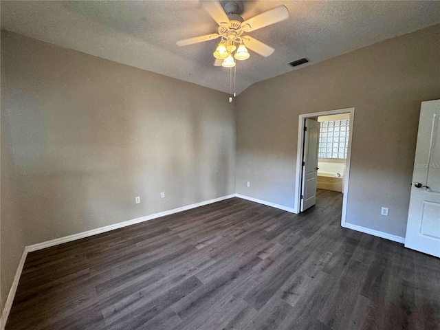 unfurnished bedroom with lofted ceiling, ceiling fan, dark wood-type flooring, and a textured ceiling