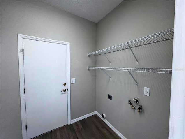 laundry area featuring gas dryer hookup, dark hardwood / wood-style flooring, and electric dryer hookup