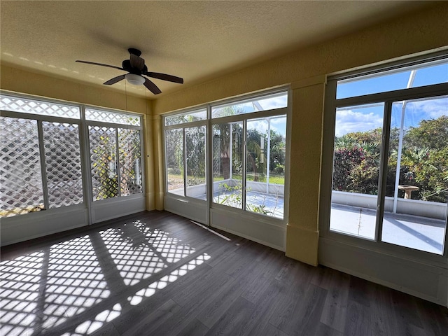 unfurnished sunroom with a healthy amount of sunlight and ceiling fan