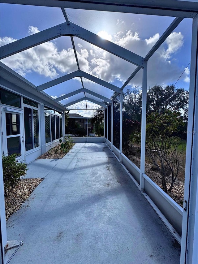 unfurnished sunroom featuring lofted ceiling