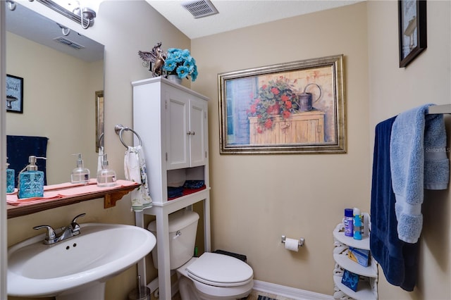 bathroom featuring sink and toilet