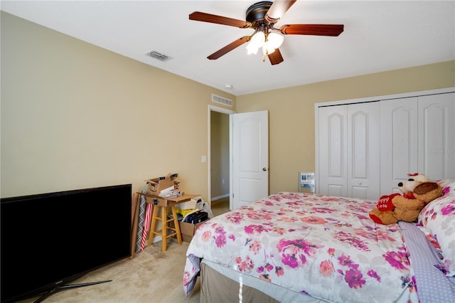 carpeted bedroom with ceiling fan and a closet