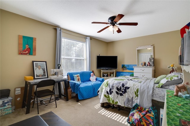 bedroom featuring light colored carpet and ceiling fan