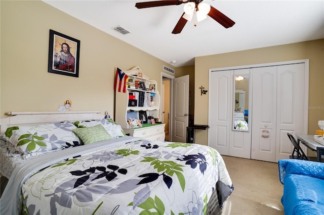 carpeted bedroom featuring a closet and ceiling fan