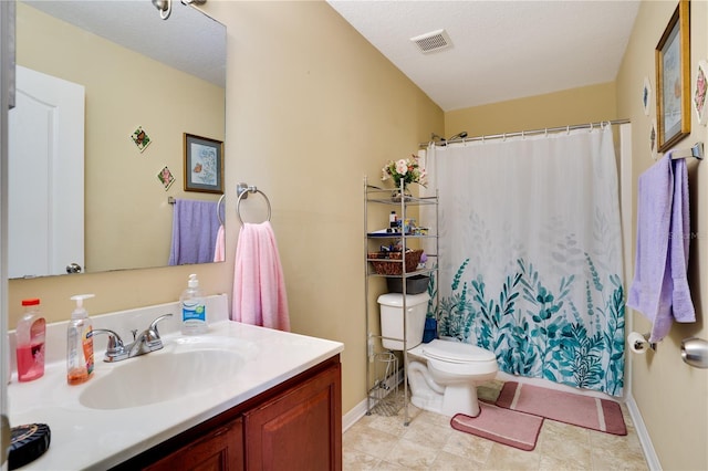 bathroom featuring vanity, curtained shower, toilet, and a textured ceiling