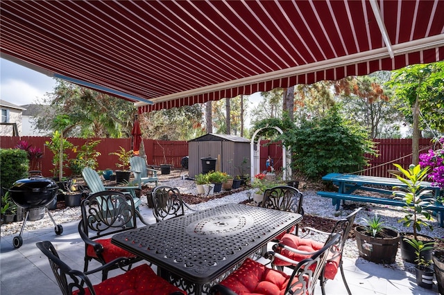 view of patio featuring area for grilling and a storage shed