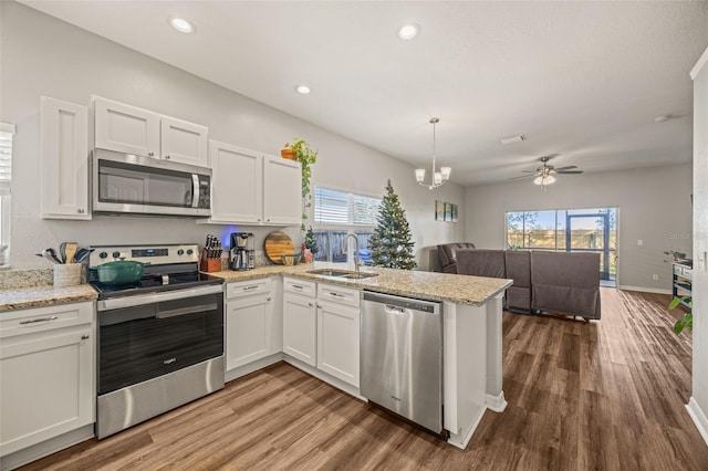 kitchen featuring a healthy amount of sunlight, sink, white cabinetry, and stainless steel appliances