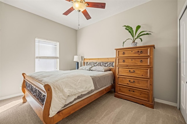 bedroom featuring light colored carpet and ceiling fan