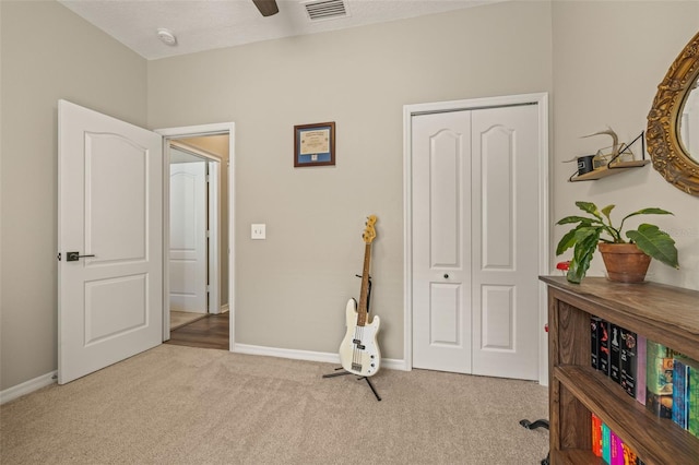 interior space featuring ceiling fan, a closet, and a textured ceiling