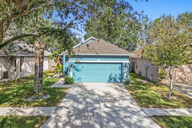 view of front of home with a front yard and a garage