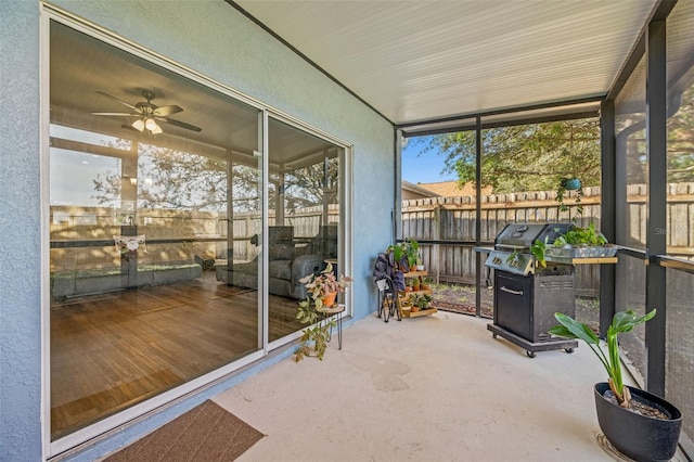 unfurnished sunroom featuring ceiling fan