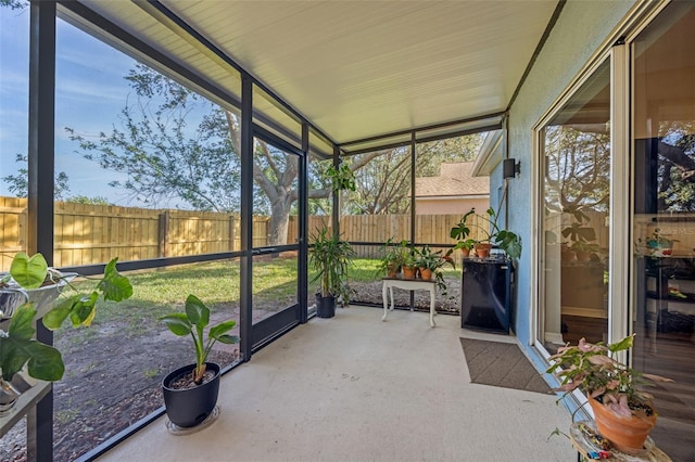 sunroom featuring lofted ceiling