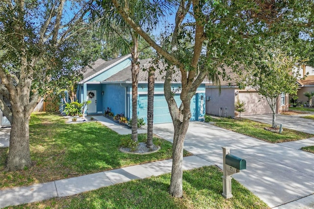 view of front of home featuring a front lawn and a garage