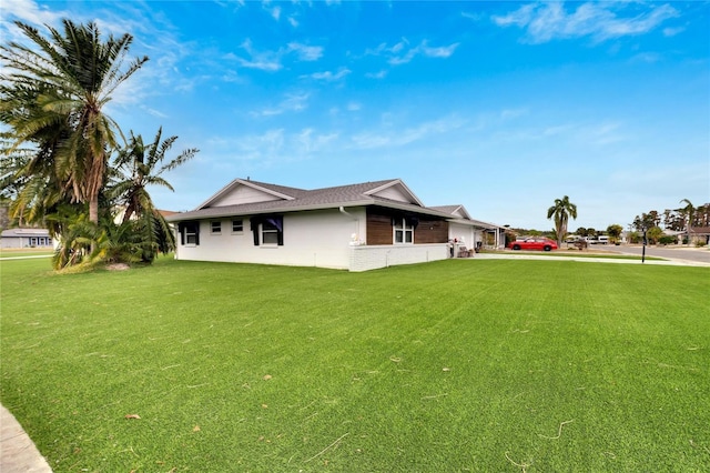 view of side of property featuring a yard