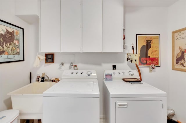 washroom featuring cabinets, independent washer and dryer, and sink