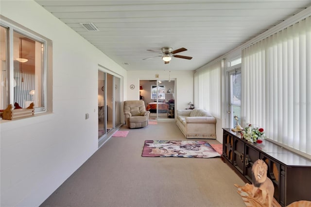 sunroom / solarium featuring ceiling fan