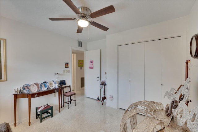 interior space with ceiling fan and a closet