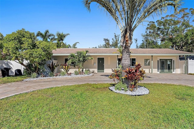 ranch-style house featuring french doors and a front lawn